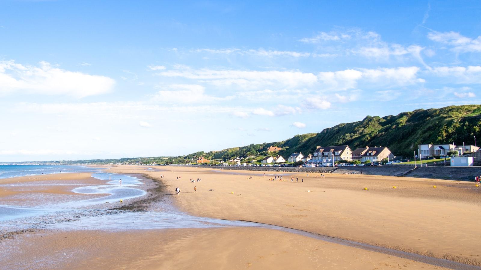 Omaha Beach at low tide with the bluffs rising behind the shore